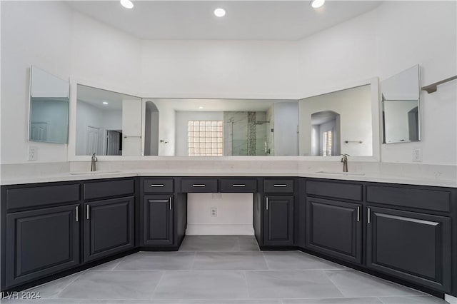 bathroom with vanity, tile patterned floors, and a shower with shower door