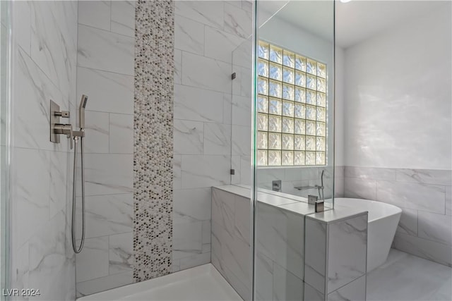 bathroom featuring separate shower and tub and tile walls