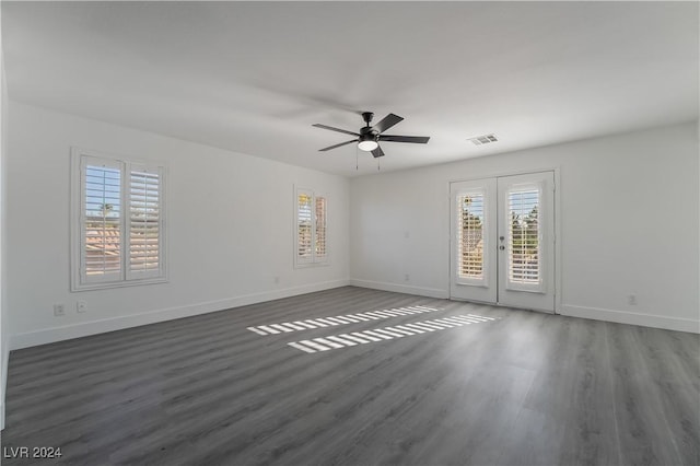 empty room featuring french doors, dark hardwood / wood-style flooring, a wealth of natural light, and ceiling fan