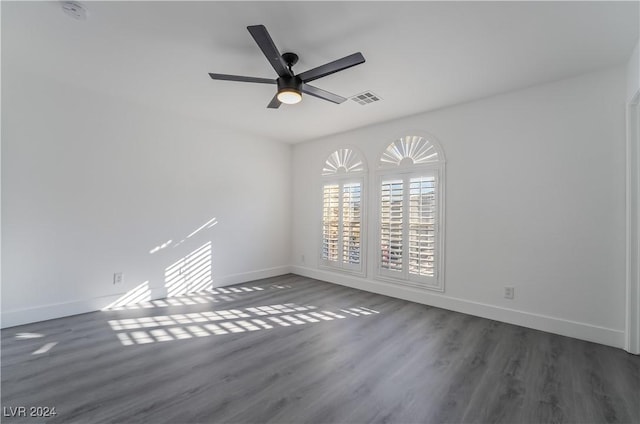 spare room featuring dark hardwood / wood-style floors and ceiling fan