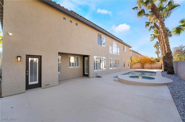 view of pool with an in ground hot tub and a patio