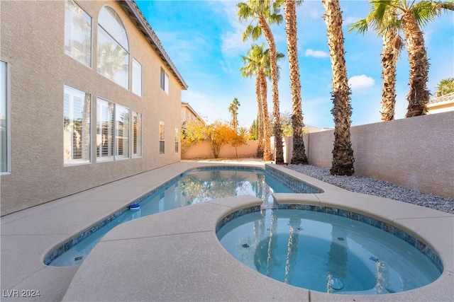 view of swimming pool featuring an in ground hot tub