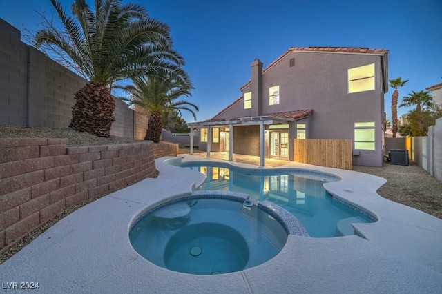 pool at dusk with an in ground hot tub, french doors, a patio area, and central air condition unit