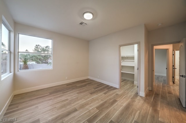 empty room with light hardwood / wood-style flooring