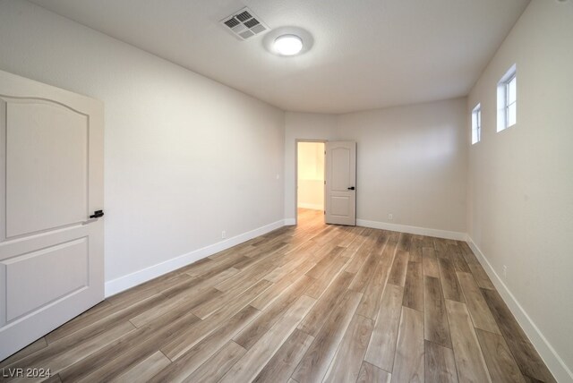 empty room with light hardwood / wood-style flooring