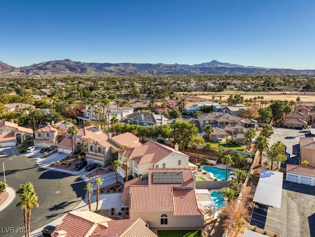 birds eye view of property with a mountain view