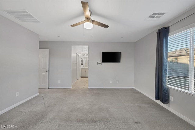 carpeted empty room featuring ceiling fan