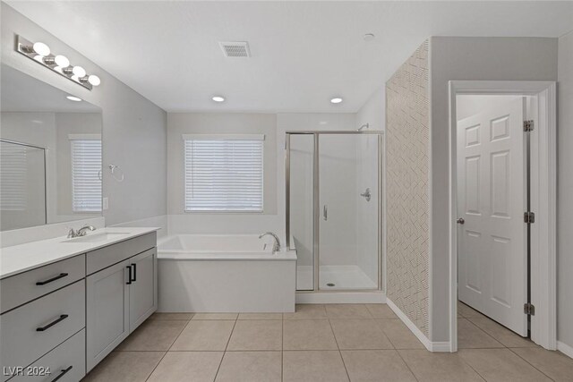 bathroom with shower with separate bathtub, vanity, and tile patterned flooring