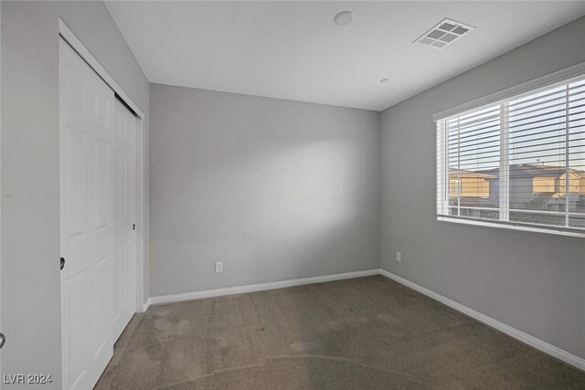 unfurnished bedroom with a closet and carpet flooring