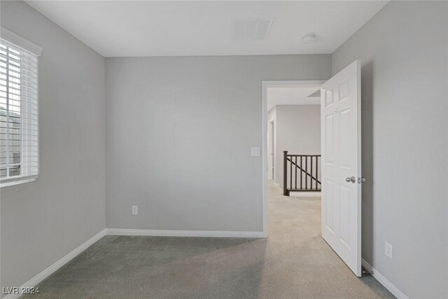 unfurnished room featuring carpet