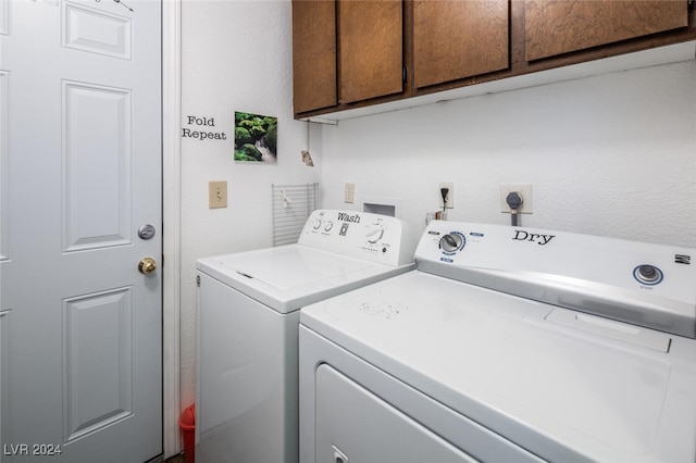 laundry room with cabinets and washing machine and dryer