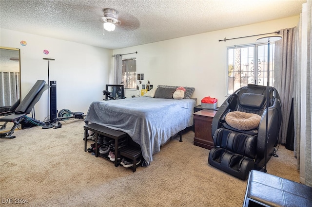 bedroom with a textured ceiling, carpet floors, and ceiling fan