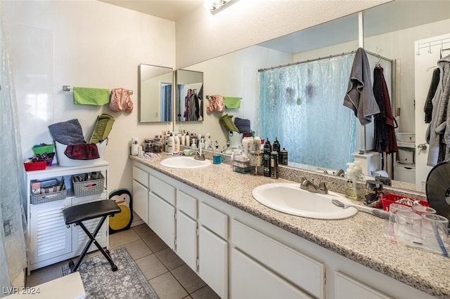 bathroom with tile patterned floors, vanity, and curtained shower