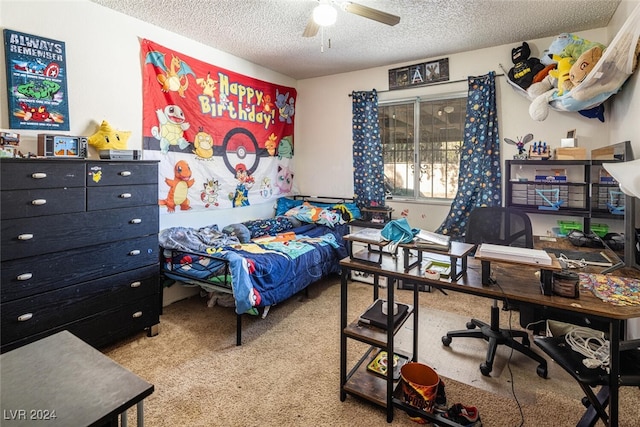 carpeted bedroom featuring ceiling fan and a textured ceiling