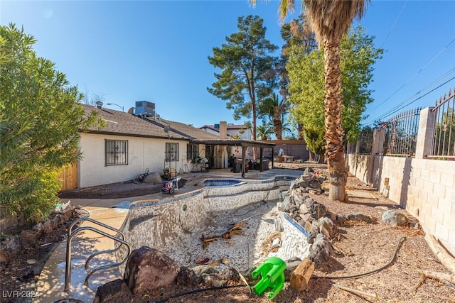 rear view of property featuring central air condition unit and a patio