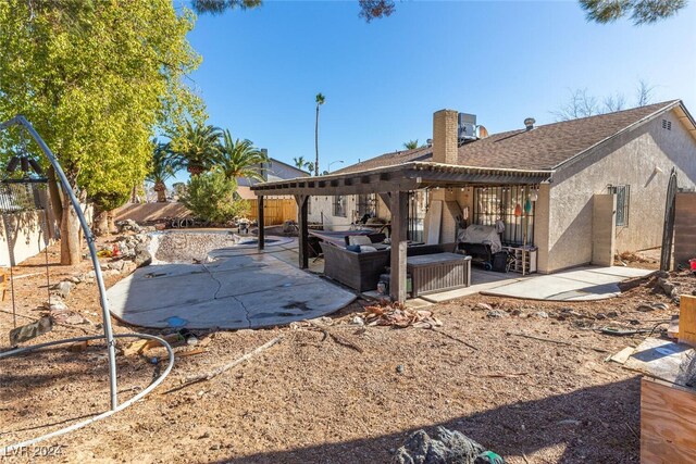 rear view of house featuring an outdoor living space and a patio