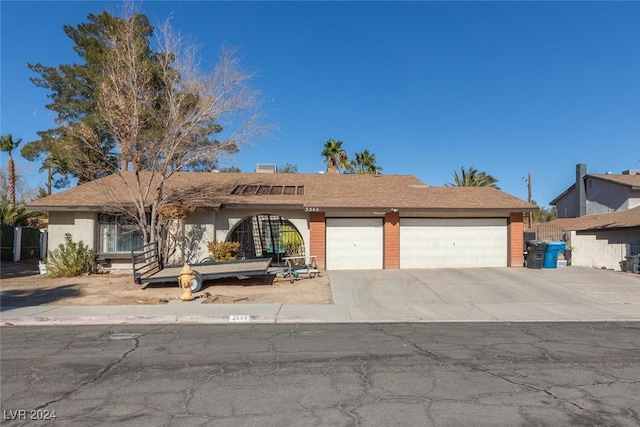 single story home featuring a garage and driveway