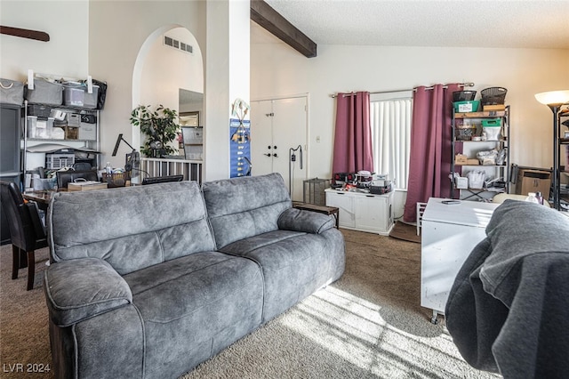 carpeted living room with beam ceiling, ceiling fan, high vaulted ceiling, and a textured ceiling