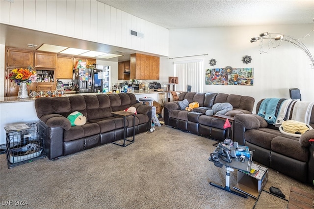 carpeted living room with a textured ceiling and vaulted ceiling