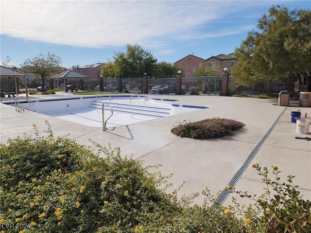 view of swimming pool with a gazebo and a patio area