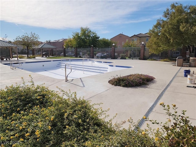 view of swimming pool with a gazebo and a patio area