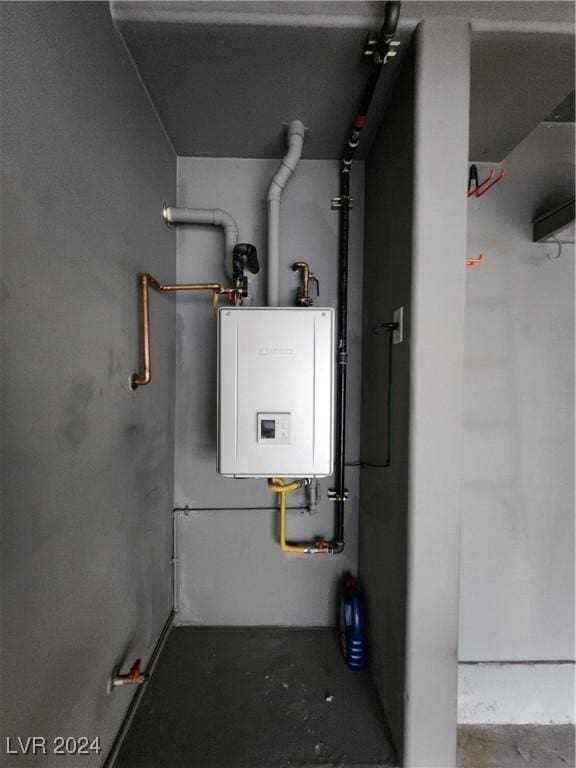 utility room featuring tankless water heater