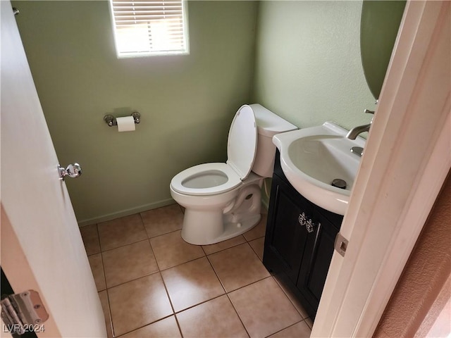 bathroom featuring toilet, vanity, and tile patterned floors