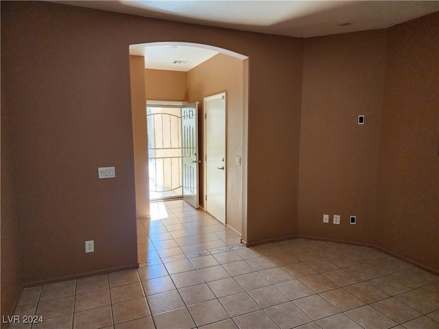 unfurnished room with light tile patterned floors