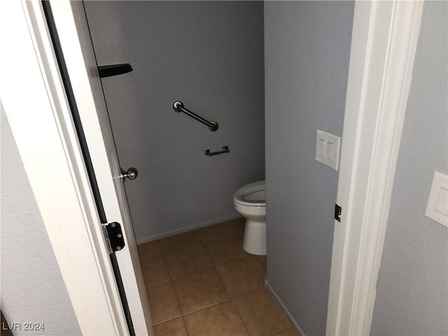 bathroom featuring tile patterned flooring and toilet