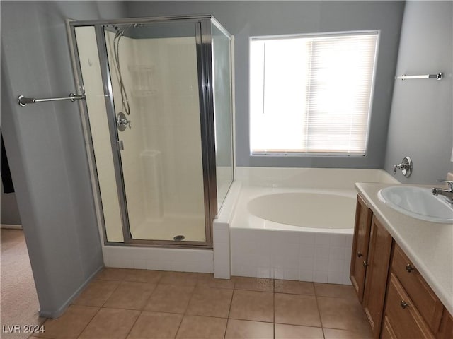 bathroom featuring tile patterned flooring, shower with separate bathtub, and vanity