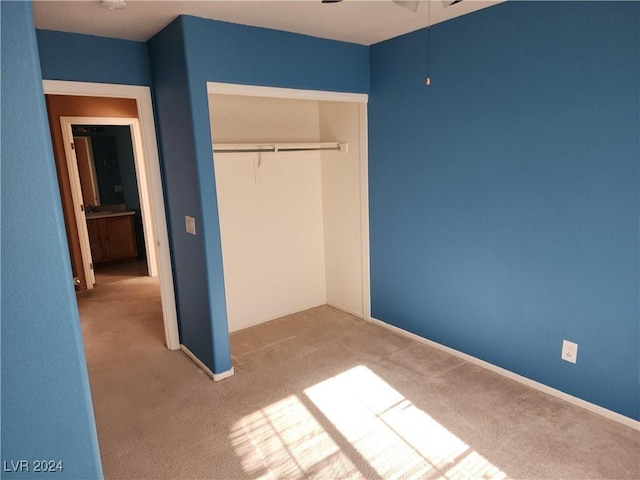 unfurnished bedroom with carpet and a closet