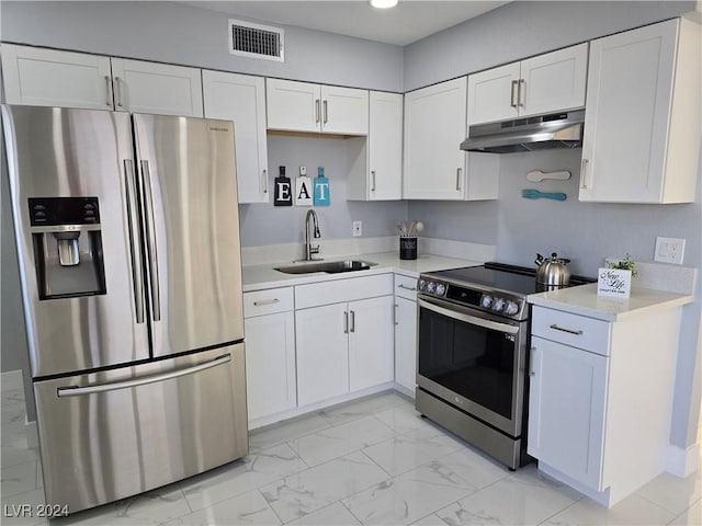 kitchen featuring white cabinets, appliances with stainless steel finishes, and sink