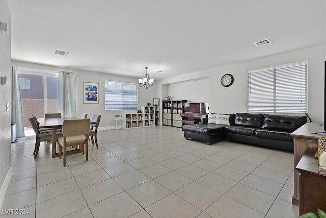 living room with a notable chandelier and light tile patterned flooring