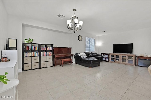 tiled living room with a notable chandelier