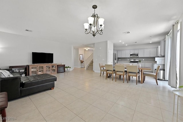 dining space with light tile patterned floors and a notable chandelier