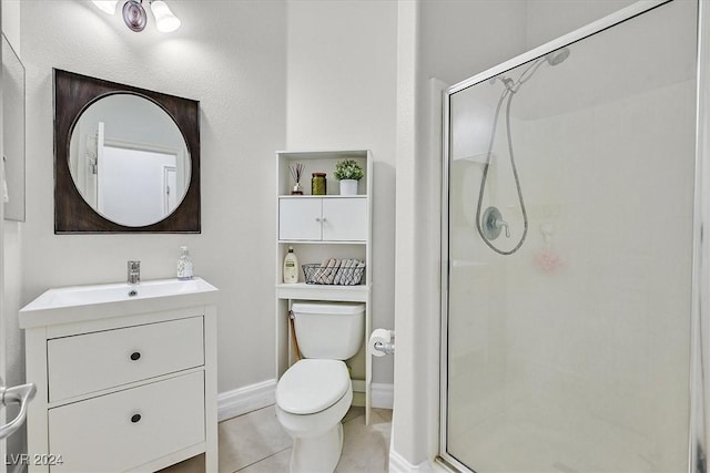 bathroom with tile patterned floors, vanity, toilet, and a shower with door