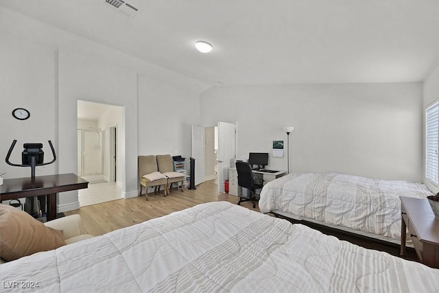 bedroom featuring hardwood / wood-style flooring and lofted ceiling