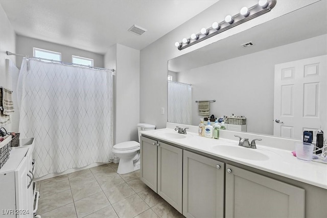 bathroom with tile patterned flooring, vanity, toilet, and a shower with shower curtain