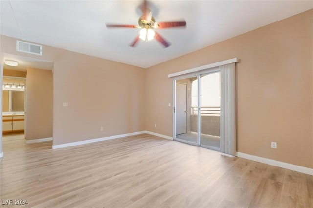 empty room featuring ceiling fan and light hardwood / wood-style flooring