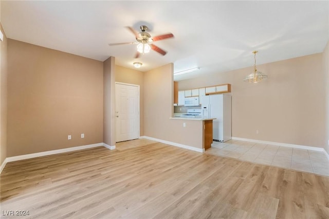 unfurnished living room with ceiling fan and light wood-type flooring