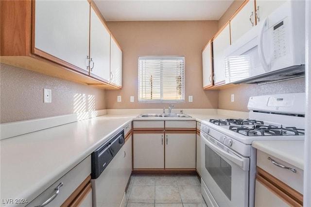 kitchen featuring white cabinets, white appliances, light tile patterned flooring, and sink