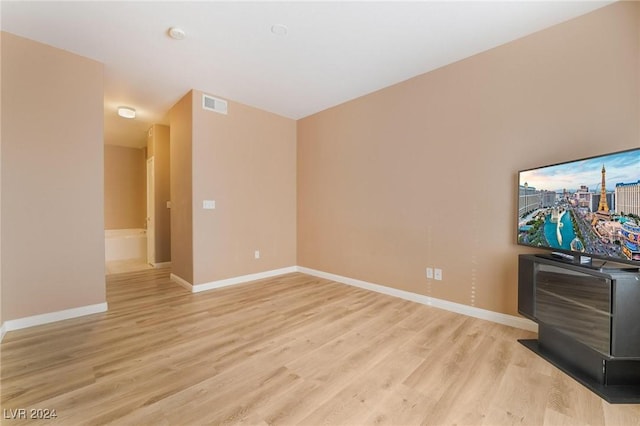 5751 E Hacienda Ave Unit 261, Las Vegas, NV 89122 - unfurnished living room with light wood-style flooring and baseboards