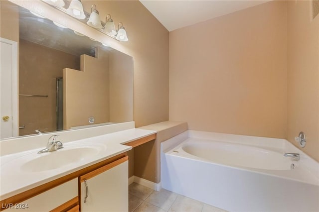 bathroom with tile patterned flooring, vanity, and a tub to relax in