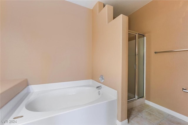 bathroom with tile patterned flooring and separate shower and tub