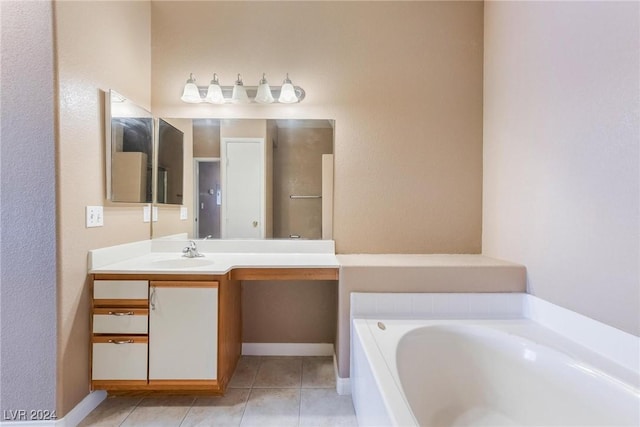 bathroom featuring tile patterned flooring, vanity, and a bathtub