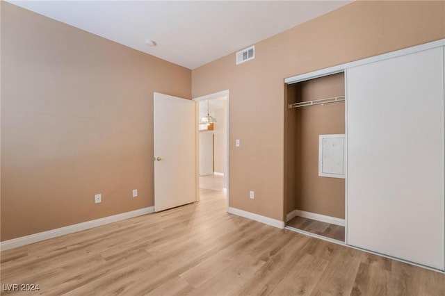 unfurnished bedroom featuring a closet and light hardwood / wood-style flooring