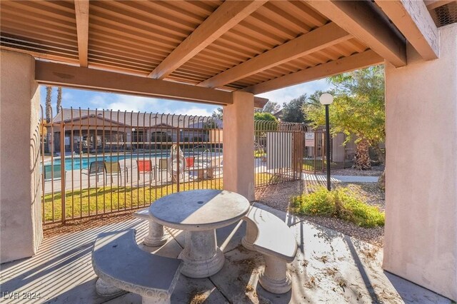 5751 E Hacienda Ave Unit 261, Las Vegas, NV 89122 - view of patio / terrace featuring a community pool and a gate
