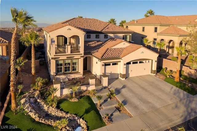 mediterranean / spanish-style home featuring a balcony and a garage