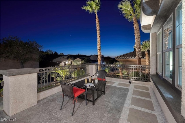 patio terrace at dusk with a balcony