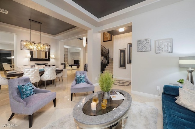 tiled living room featuring a chandelier